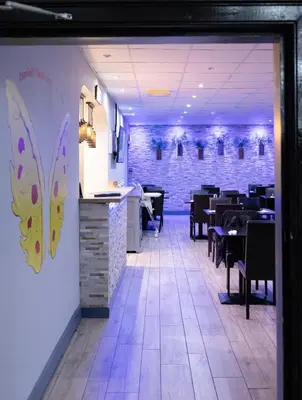 a dining room with tables and chairs and a brick wall at The County Hotel in Helensburgh