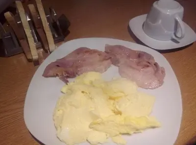 a plate of food with meat and potatoes on a table at Maggie's in Inveraray