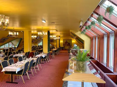 a restaurant with tables and chairs in a room at Muthu Ben Doran Hotel in Tyndrum
