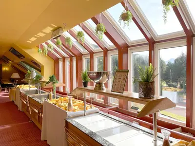 a kitchen with a bunch of food in a room with windows at Muthu Ben Doran Hotel in Tyndrum