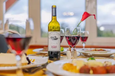 a bottle of wine sitting on a table with wine glasses at Muthu Ben Doran Hotel in Tyndrum