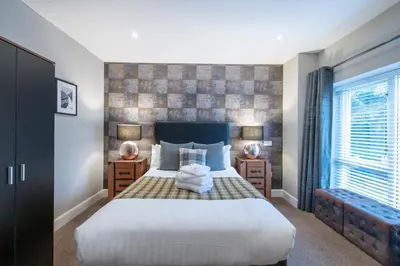 a bedroom with a large bed and a window at The Allan Park in Stirling