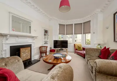 a living room with couches and a fireplace at The Lauderdale Street Residence in Edinburgh