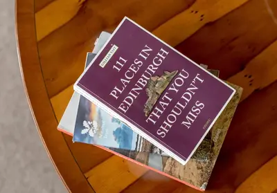 two books sitting on top of a table at The Lauderdale Street Residence in Edinburgh