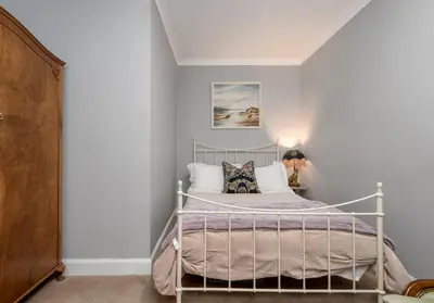 a bedroom with a white bed in a room at The Lauderdale Street Residence in Edinburgh
