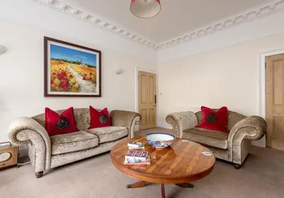 a living room with two couches and a table at The Lauderdale Street Residence in Edinburgh