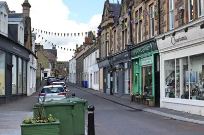 a city street with cars parked on the street at Cobbler's Cottage in Dunblane