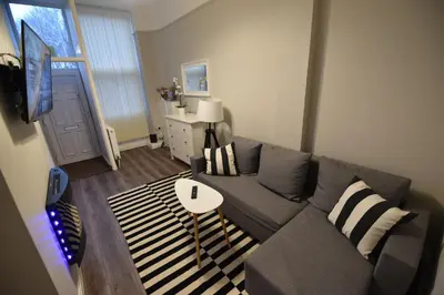 a living room with a couch and a table at Slateford House Apartment Ground Floor Main Door in Edinburgh