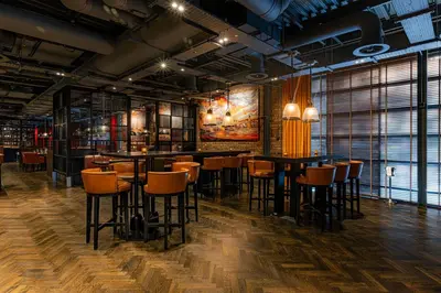 a restaurant with tables and chairs in a room at Dakota Edinburgh in Queensferry
