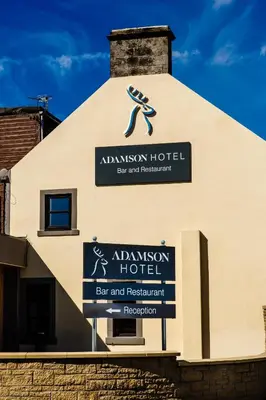 a sign on the side of a building at Adamson Hotel in Dunfermline