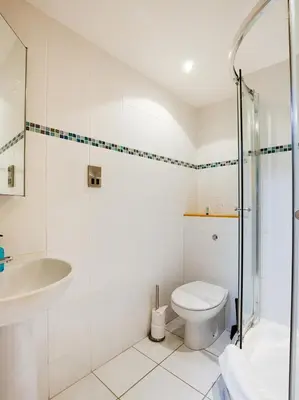 a bathroom with a shower toilet and a sink at Auld Mill House Hotel in Dunfermline
