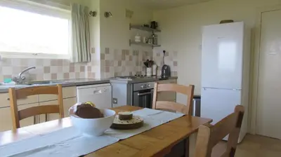 a kitchen with a table with a bowl of food on it at Aird Farm Holiday Cottages in Ardfern