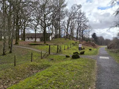 a dirt road leading to a house on a hill at Rob Roy Hotel in Aberfoyle