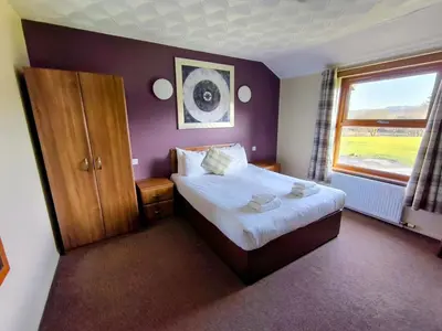 a hotel room with a bed and a window at Rob Roy Hotel in Aberfoyle