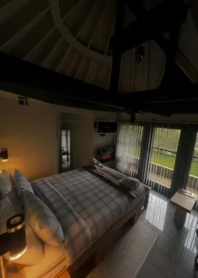 a bedroom with a bed in a room with windows at Ivybank Villa in Rothesay