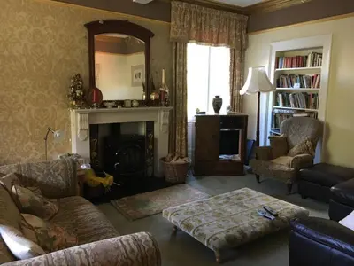 a living room with a couch and a fireplace at Rosebank House Bed & Breakfast in Strathyre