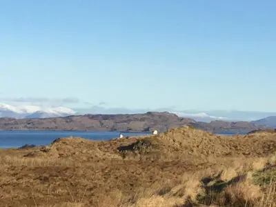 a view of a body of water and some mountains at Oban Seil Farm The Bothy in Clachan