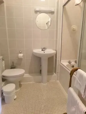 a bathroom with a sink and a toilet and a shower at Averon Guest House in Edinburgh