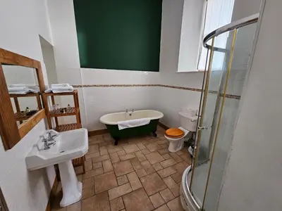 a bathroom with a sink and a toilet and a shower at Broomhall Castle Hotel in Stirling