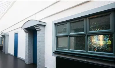 a row of windows on the side of a building at Cunninghame 1 in Beith