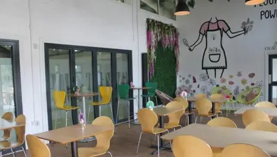 a restaurant with tables and chairs and a wall with a dress on it at Cunninghame 1 in Beith