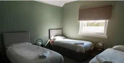 a room with two beds and a window at Cunninghame 1 in Beith