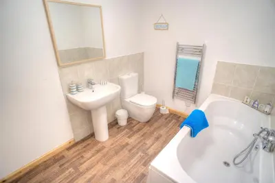 a bathroom with a sink and a tub and a toilet at ArdFyne on Lochfyne in Strachur