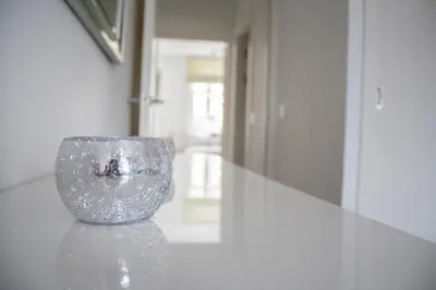 a glass vase sitting on a counter in a room at Lexington Apartments in Rothesay
