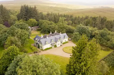 an aerial view of a large house in the countryside at Lagafater Lodge in Glenwhilly