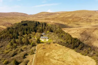 an aerial view of a house in the middle of a forest at Lagafater Lodge in Glenwhilly