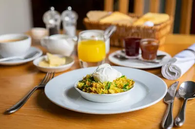 a table with a plate of food with a bowl of food at Trigony Hotel and Garden Spa in Closeburn