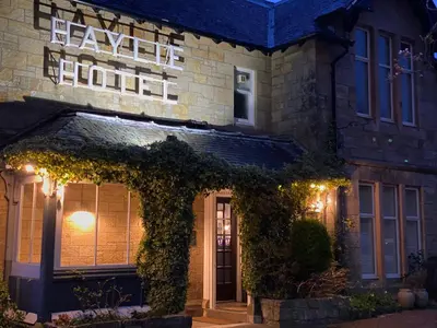 a building with a sign that reads leave the hotel at Haylie Hotel in Largs