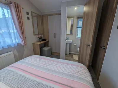 a small bedroom with a bed and a bathroom at The Manor Sea View 8 in Dunoon