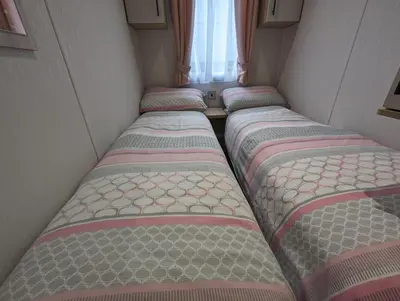 a row of beds in a small room at The Manor Sea View 8 in Dunoon