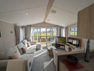 a living room with a couch and a tv at The Manor Sea View 8 in Dunoon