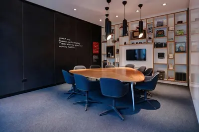 a conference room with a wooden table and chairs at citizenM Glasgow in Glasgow