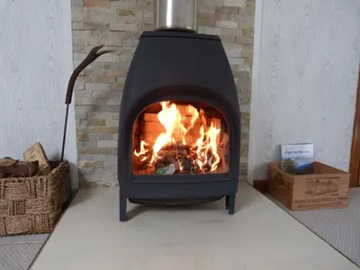 a fireplace with a fire in it in a room at The Steading at Barmore in Tarbert