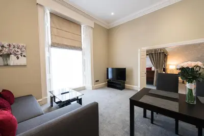 a living room with a couch and a table at Royal Princes Suites in Edinburgh