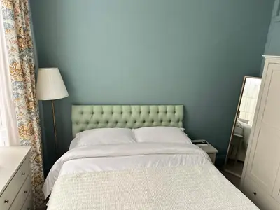 a bedroom with a large bed with a blue wall at Georgian House in Edinburgh