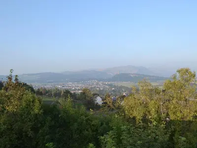 a view of a city from a hill with trees at Craigdarroch Cottage in Strathyre