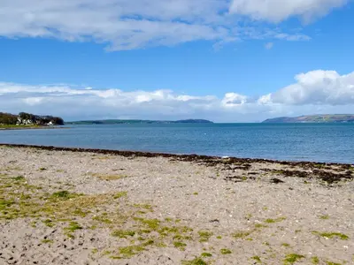 a beach with a large body of water at Park View Cottage in Stranraer