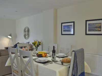 a dining room table with a white table cloth and food on it at Casa Duran in Killin