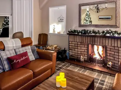a living room with a couch and a fireplace at Thornbank in Millport
