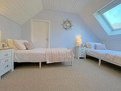 a bedroom with two beds and a window at Thornbank in Millport