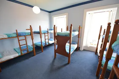 a room with four bunk beds and a window at Oban Backpackers in Oban