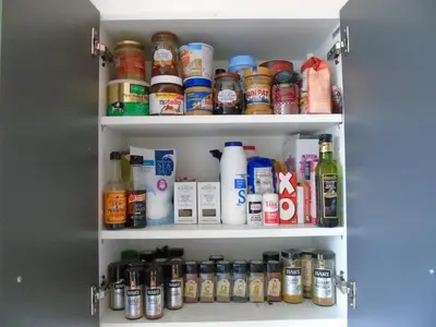 a pantry filled with lots of different types of alcohol at Snug - Krayr Apartment in Helensburgh