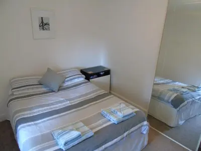 a bedroom with two beds with towels on them at Snug - Krayr Apartment in Helensburgh