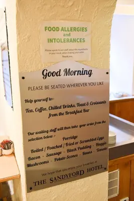a sign on a wall with food allergies and intolerances at Sandyford Hotel in Glasgow