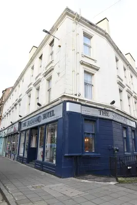 a building on a street in front at Sandyford Hotel in Glasgow