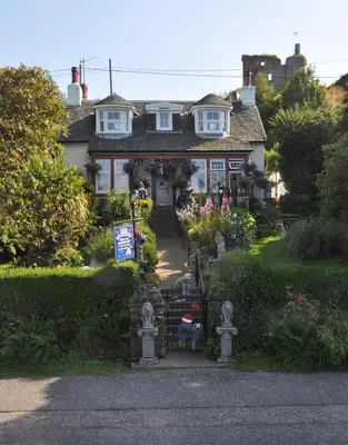 a house with a staircase leading to the front yard at The Moorings in Tarbert